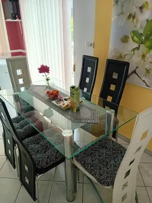 a glass dining room table with chairs and a glass table and chairs at Apartma Peter1a in Begunje na Gorenjskem