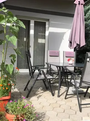 a patio with a table and chairs and an umbrella at Apartma Peter1a in Begunje na Gorenjskem