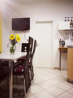 a dining room with a table and chairs with a vase of flowers at Apartma Peter1a in Begunje na Gorenjskem