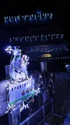 a sign with a snowman with lights on it at Snežak (Snowman) 2 in Bohinj