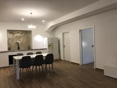 a dining room with a table and chairs and a refrigerator at Jure apartment in Ljubljana in Ljubljana