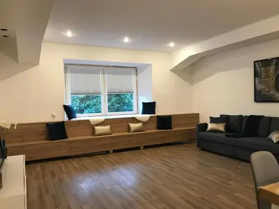 a living room with a couch and a window at Jure apartment in Ljubljana in Ljubljana