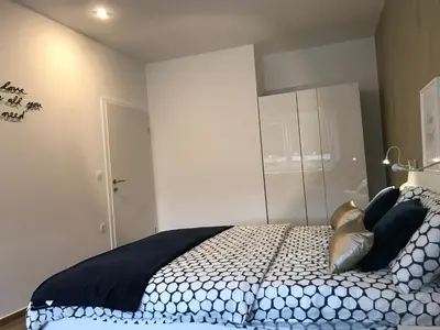 a bedroom with a bed with black and white pillows at Jure apartment in Ljubljana in Ljubljana