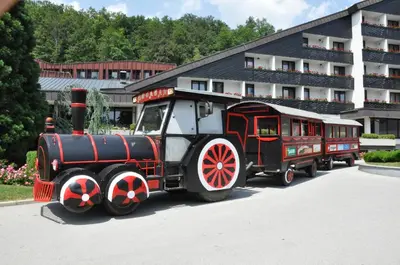 a train on display in front of a building at Vas Lipa 8 - 36 in Podčetrtek