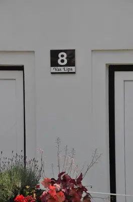 a sign on the side of a building with aosis sign at Vas Lipa 8 - 36 in Podčetrtek