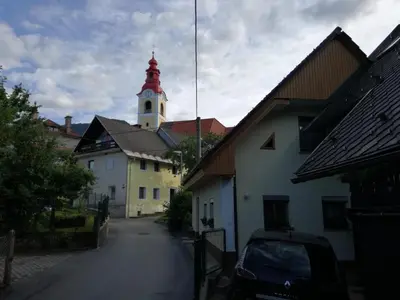 a street with a building with a clock tower at Apartma Pr Martin in Begunje na Gorenjskem