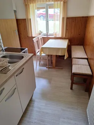 a kitchen with a sink and a table and chairs at Apartma Pr Martin in Begunje na Gorenjskem