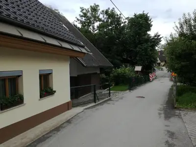 an empty street next to a house at Apartma Pr Martin in Begunje na Gorenjskem