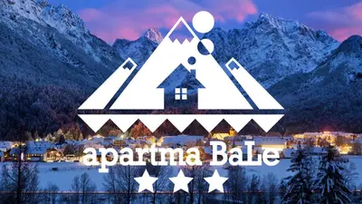 a sign for a ski resort with mountains in the background at Apartma BaLe in Kranjska Gora