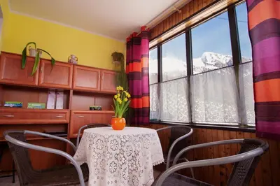 a dining room with a table and chairs and a window at Apartmaji Berginc in Kobarid