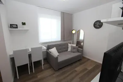 a living room with a couch and a table at Elegant central Apt Maribor w/Parking in Maribor