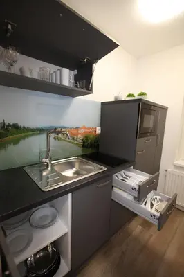 a kitchen with a sink and a counter top at Elegant central Apt Maribor w/Parking in Maribor