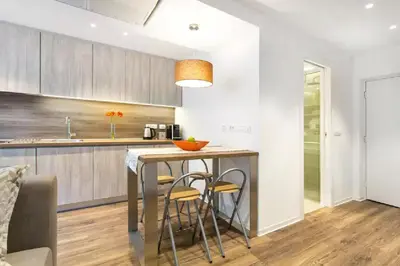 a kitchen with a table and two stools at ★ Exclusive Central Apartment ★ FREE Garage ★ in Ljubljana