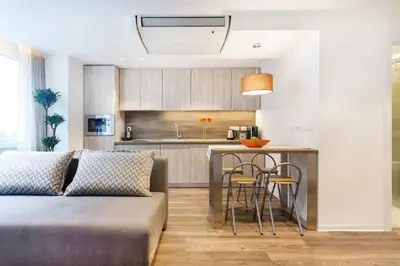 a kitchen and living room with a couch and a table at ★ Exclusive Central Apartment ★ FREE Garage ★ in Ljubljana