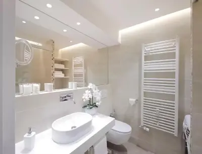 a white bathroom with a sink and a toilet at ★ Exclusive Central Apartment ★ FREE Garage ★ in Ljubljana