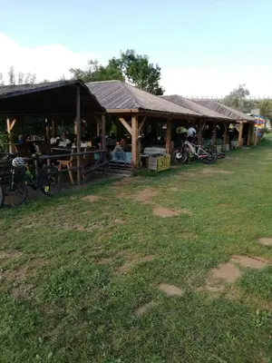 a wooden pavilion with bikes parked in a field at Apartment Antonia in Dobova