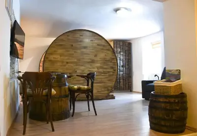 a room with a table and chairs and a large barrel at Apartments FABRKA in Ljubljana