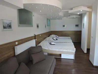 a living room with two beds and a couch at Gostilna PIK in Prevalje