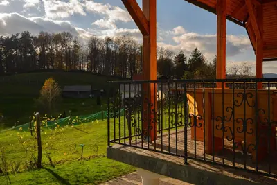 a gazebo with a view of a green field at Holiday Home Dobrotin in Vojnik