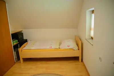 a small bedroom with a bed in a room at Holiday Home Dobrotin in Vojnik