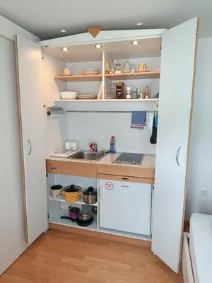 a kitchen with white cabinets and a sink at Sobe Černilogar in Tolmin