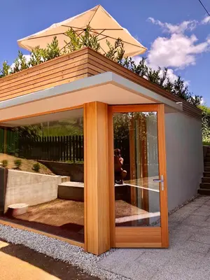 a glass door of a house with a person behind it at HOMe apartments & Yoga studio in Bled-Rečica