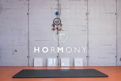 a room with a sign and a clock and a yoga mat at HOMe apartments & Yoga studio in Bled-Rečica