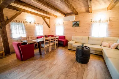 a living room with a couch and a table at Sunny House with Sauna in Bistrica ob Sotli