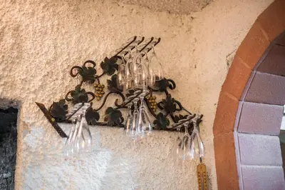 a bunch of wine glasses hanging from a wall at Sunny House with Sauna in Bistrica ob Sotli