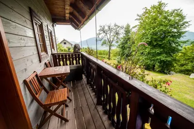 a porch with two benches and a view of a yard at Sunny House with Sauna in Bistrica ob Sotli