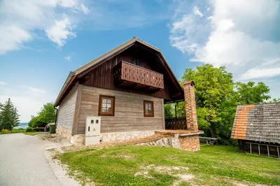 a small wooden house with a roof at Sunny House with Sauna in Bistrica ob Sotli
