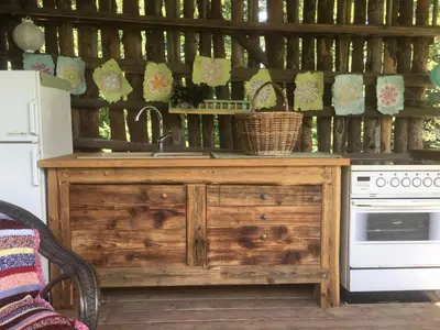 a kitchen with a wooden counter with a sink and a stove at Blue Cottage in Podvrh