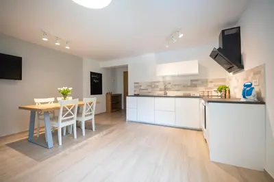 a kitchen and dining room with a table and chairs at Hiša Urška in Log pod Mangartom