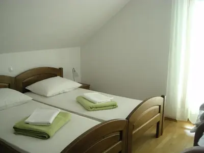 two beds in a room with two towels on them at Turistična Kmetija Logar in Grahovo