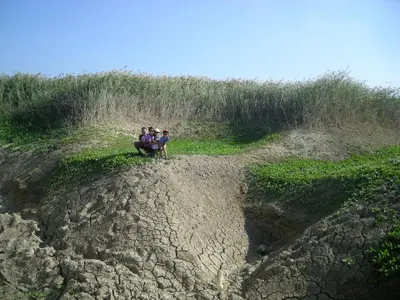 a group of people standing on top of a dirt hill at Turistična Kmetija Logar in Grahovo