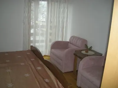 a living room with a couch and a chair at Turistična Kmetija Logar in Grahovo