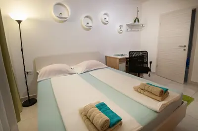 a bedroom with a bed with towels on it at Apartment MATEA in Kobarid