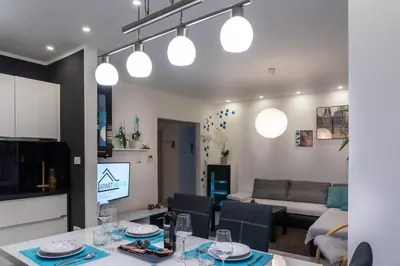 a kitchen and living room with a table and chairs at Apartment MATEA in Kobarid