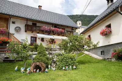 a group of figurines in the grass in front of a house at Apartments Kocjanc in Bohinj