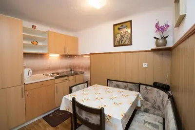 a kitchen with a table and chairs in a room at Apartments Kocjanc in Bohinj