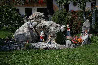 a group of figurines in a rock garden at Apartments Kocjanc in Bohinj