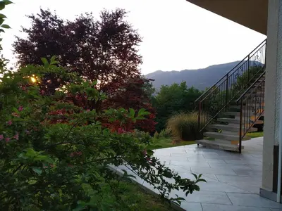 a staircase leading to a house with flowers at Apartma Kapitanovše in Ajdovščina