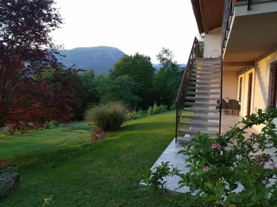 a stairway to a house with a grass yard at Apartma Kapitanovše in Ajdovščina
