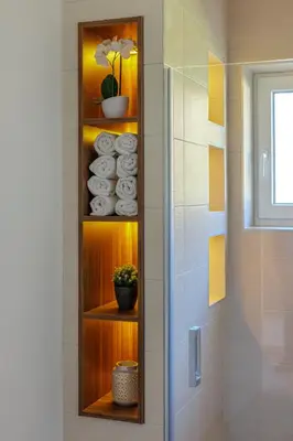 a bathroom with a wooden shelf with towels at Apartma Kapitanovše in Ajdovščina