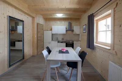 a kitchen and dining room with a table and chairs at 1861 Blejka apartments Bled in Bled