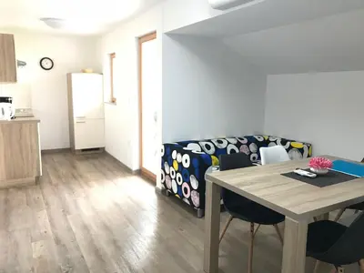 a living room with a table and a couch at 1861 Blejka apartments Bled in Bled