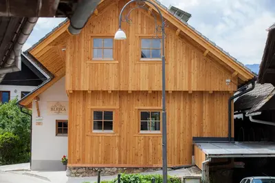 a house being built with wood panels at 1861 Blejka apartments Bled in Bled