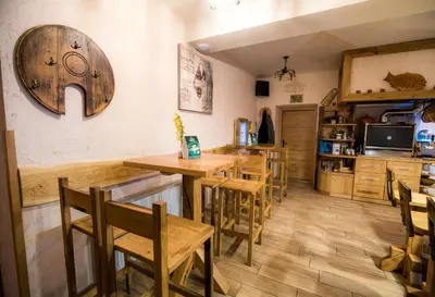 a dining room with wooden tables and chairs at Guest House Frata in Dvor