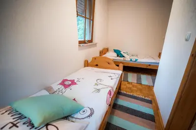 a small room with two beds and a window at Guest House Frata in Dvor
