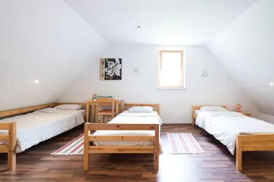 a room with three beds and a window at Yellow house in Trenta
